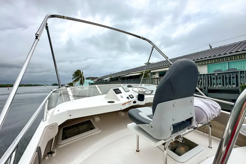  Yacht Photos Pics 2022 Cutwater 30 Command Bridge boat interior with steering wheel and captain's chair.