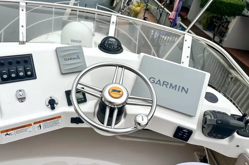  Yacht Photos Pics 2022 Cutwater 30 Command Bridge helm with Garmin navigation system and steering wheel.