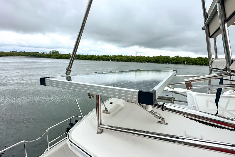  Yacht Photos Pics 2022 Cutwater 30 Command Bridge with solar panel on deck, overlooking serene waters.