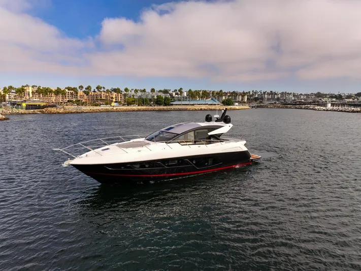 Veni Vici Yacht Photos Pics 2019 Sunseeker Predator 57 yacht cruising in a scenic harbor.