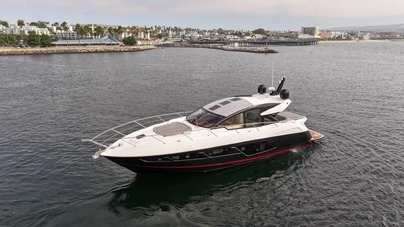 Veni Vici Yacht Photos Pics 2019 Sunseeker Predator 57 yacht cruising in a scenic coastal area.