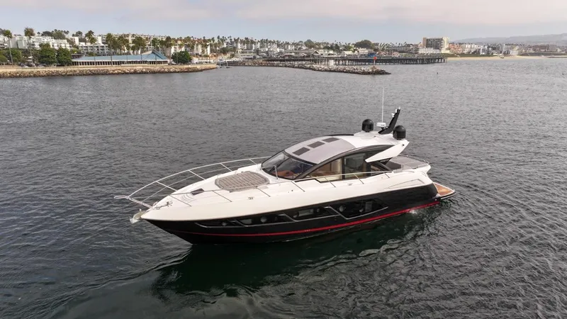 Veni Vici Yacht Photos Pics 2019 Sunseeker Predator 57 yacht cruising in a calm harbor setting.