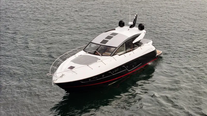 Veni Vici Yacht Photos Pics 2019 Sunseeker Predator 57 yacht on calm water, showcasing sleek design and luxury features.