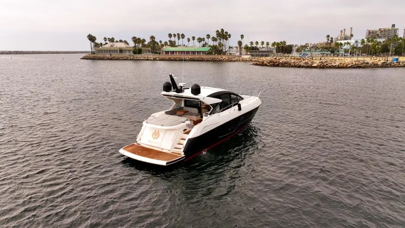 Veni Vici Yacht Photos Pics 2019 Sunseeker Predator 57 yacht cruising near a coastal marina.