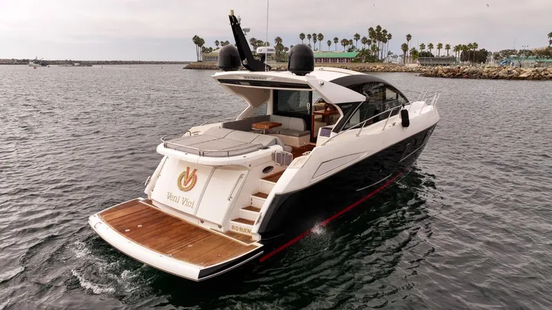 Veni Vici Yacht Photos Pics 2019 Sunseeker Predator 57 yacht cruising in a scenic harbor setting.