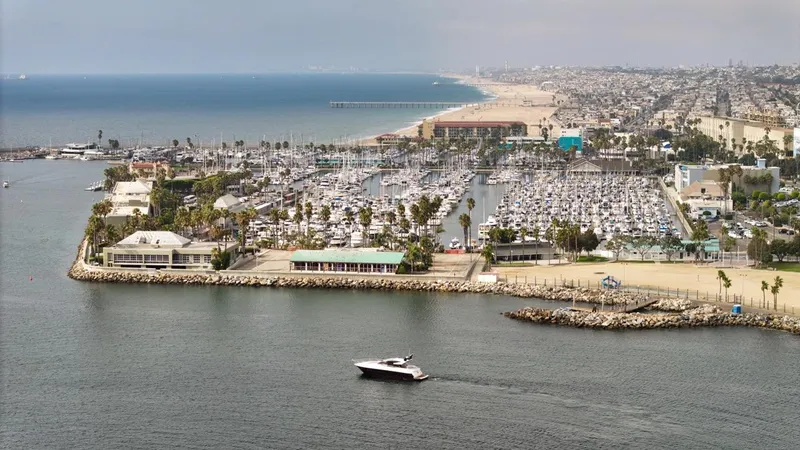 Veni Vici Yacht Photos Pics Aerial view of 2019 Sunseeker Predator 57 yacht near a bustling marina and coastline.