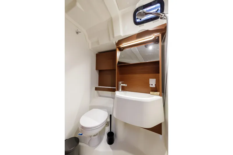  Yacht Photos Pics Modern bathroom in 2019 Beneteau Oceanis 51.1 yacht with sleek fixtures and wood accents.