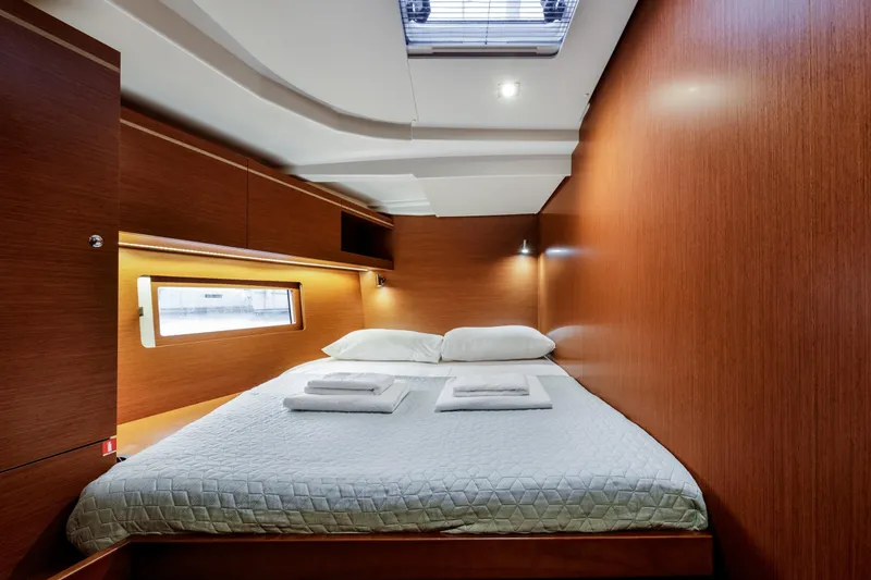  Yacht Photos Pics Luxurious cabin interior of 2019 Beneteau Oceanis 51.1 yacht with cozy bedding.