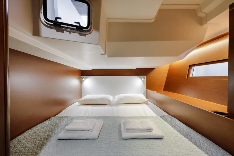  Yacht Photos Pics Luxurious cabin interior of 2019 Beneteau Oceanis 51.1 yacht with cozy bedding.