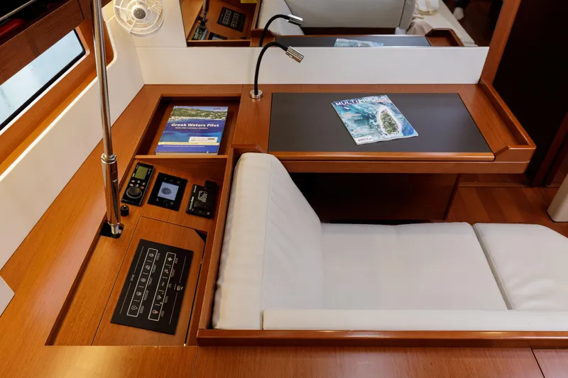  Yacht Photos Pics Interior of 2019 Beneteau Oceanis 51.1 yacht with navigation station and comfortable seating.