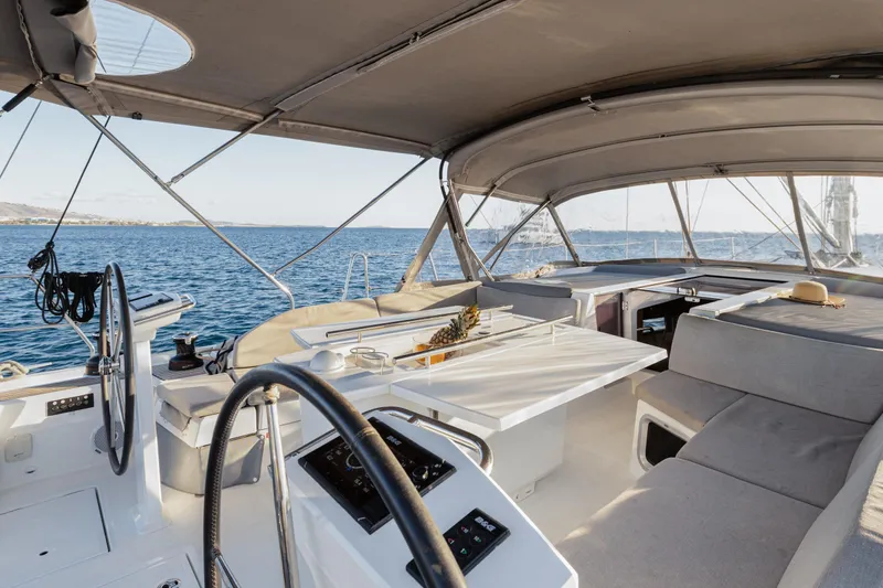  Yacht Photos Pics Luxurious 2019 Beneteau Oceanis 51.1 yacht cockpit with seating, table, and ocean view.
