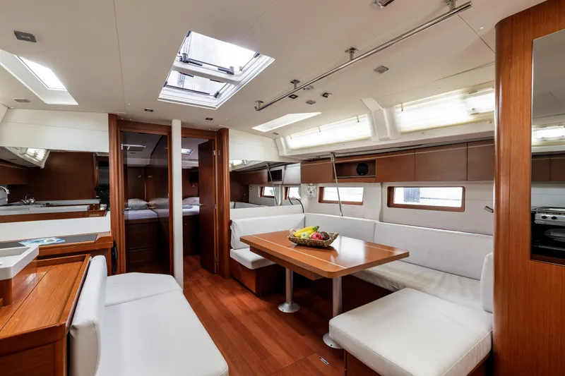  Yacht Photos Pics Luxurious interior of 2019 Beneteau Oceanis 51.1 yacht with modern dining area.