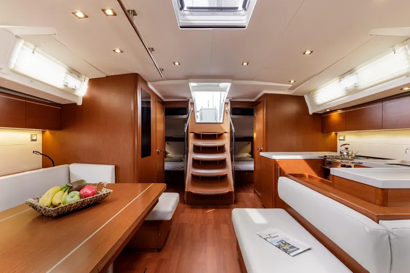  Yacht Photos Pics Luxurious interior of 2019 Beneteau Oceanis 51.1 yacht with modern dining and kitchen area.