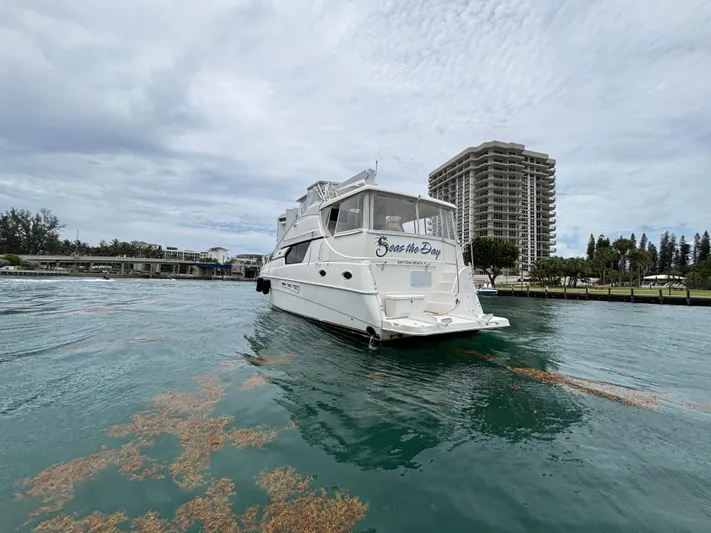 Seas The Day Yacht Photos Pics 2000 Silverton 453 Motor Yacht on water near high-rise buildings.