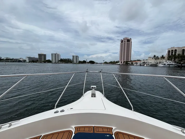 Seas The Day Yacht Photos Pics Bow view from 2000 Silverton 453 Motor Yacht, overlooking waterfront cityscape.