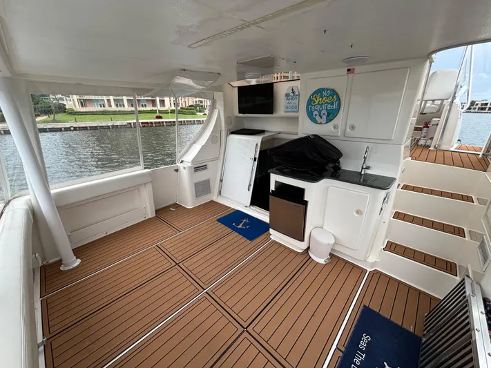 Seas The Day Yacht Photos Pics 2000 Silverton 453 Motor Yacht interior with wood flooring, kitchenette, and waterfront view.