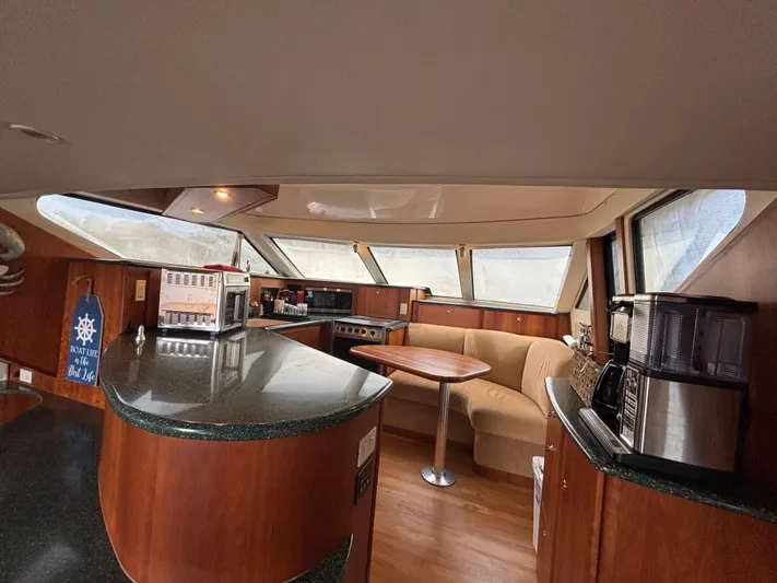 Seas The Day Yacht Photos Pics Interior of 2000 Silverton 453 Motor Yacht with kitchen and seating area.