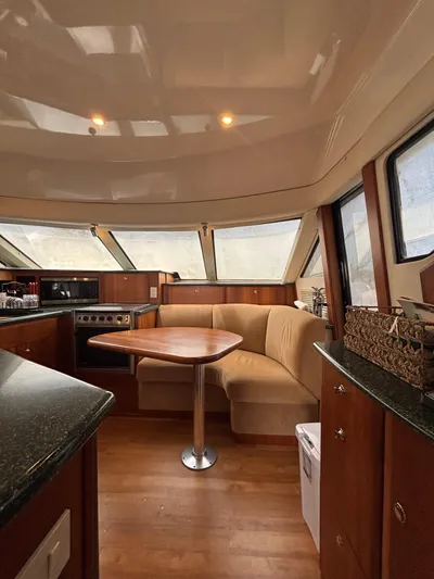 Seas The Day Yacht Photos Pics Interior of 2000 Silverton 453 Motor Yacht with cozy seating and modern kitchen amenities.