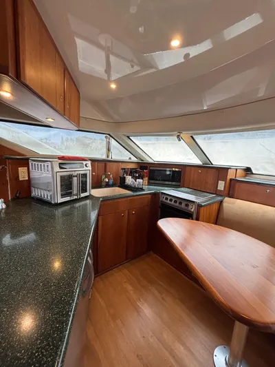 Seas The Day Yacht Photos Pics Interior of 2000 Silverton 453 Motor Yacht kitchen with modern appliances and wood finish.