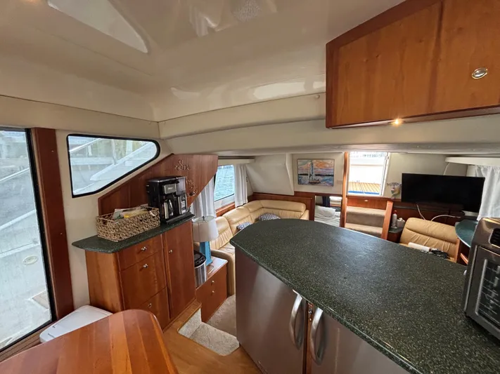 Seas The Day Yacht Photos Pics Interior of 2000 Silverton 453 Motor Yacht with modern kitchen and cozy seating area.
