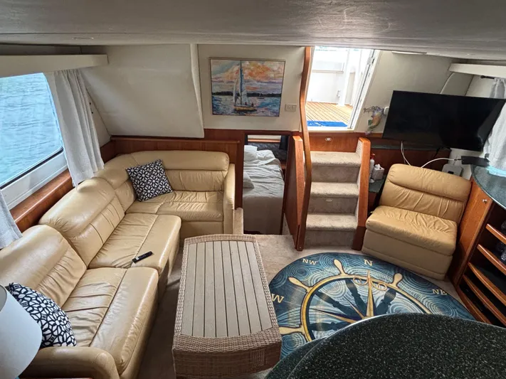 Seas The Day Yacht Photos Pics Luxurious interior of 2000 Silverton 453 Motor Yacht with leather seating and nautical decor.