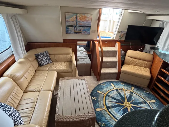 Seas The Day Yacht Photos Pics Interior of 2000 Silverton 453 Motor Yacht with beige seating and nautical decor.