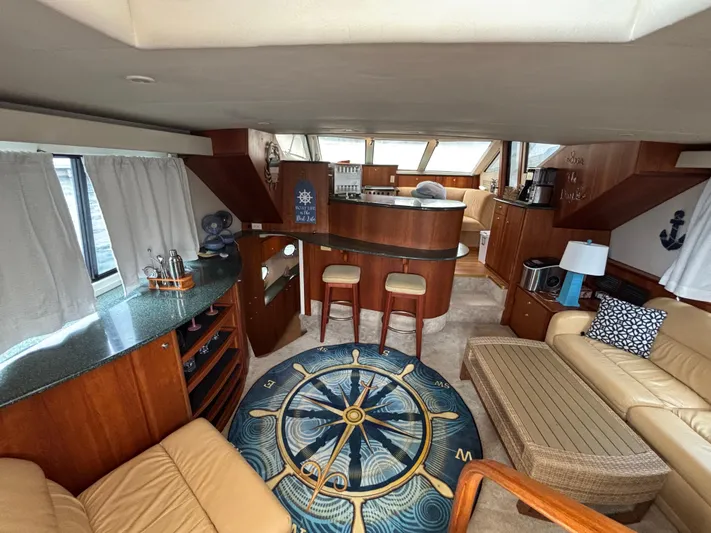 Seas The Day Yacht Photos Pics Interior of a 2000 Silverton 453 Motor Yacht with elegant wood finishes and nautical decor.