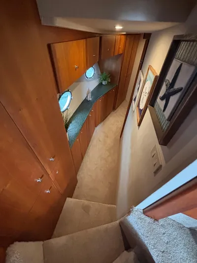 Seas The Day Yacht Photos Pics Interior hallway of 2000 Silverton 453 Motor Yacht with wood cabinets and porthole windows.