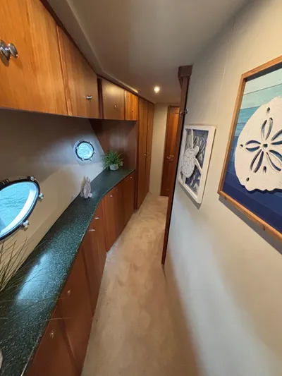 Seas The Day Yacht Photos Pics Interior hallway of 2000 Silverton 453 Motor Yacht with wood cabinets and nautical decor.