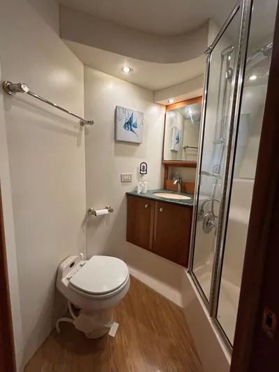 Seas The Day Yacht Photos Pics Bathroom interior of 2000 Silverton 453 Motor Yacht with shower and wooden flooring.