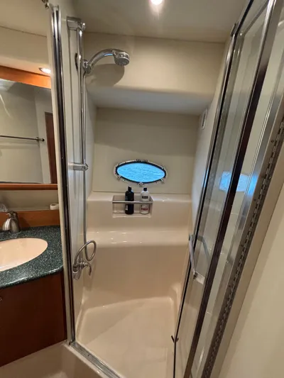 Seas The Day Yacht Photos Pics Bathroom interior of 2000 Silverton 453 Motor Yacht with shower and porthole window.