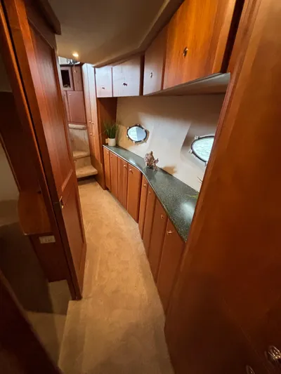 Seas The Day Yacht Photos Pics Interior of 2000 Silverton 453 Motor Yacht with wood cabinetry and porthole windows.