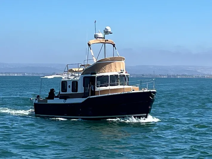 Together Again II Yacht Photos Pics 2022 Ranger Tugs R-31 CB cruising on open water under clear blue skies.