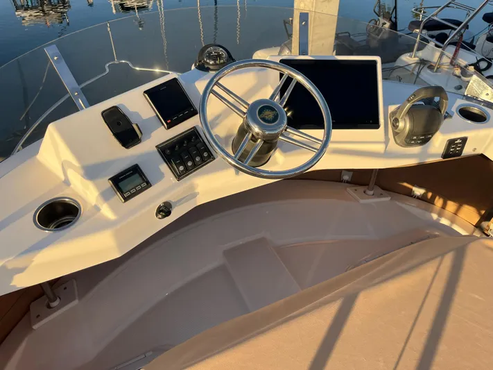 Together Again II Yacht Photos Pics 2022 Ranger Tugs R-31 CB helm with modern navigation equipment and steering wheel.