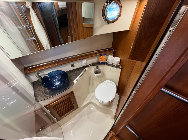 Together Again II Yacht Photos Pics Luxurious bathroom in 2022 Ranger Tugs R-31 CB with modern fixtures and wood accents.