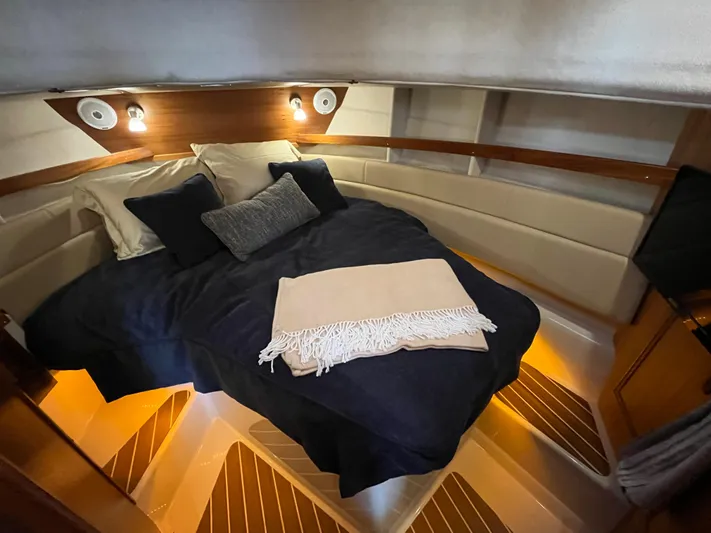 Together Again II Yacht Photos Pics Cozy cabin interior of 2022 Ranger Tugs R-31 CB with ambient lighting and plush bedding.