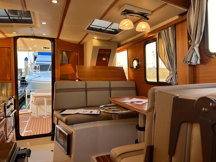 Together Again II Yacht Photos Pics Luxurious interior of 2022 Ranger Tugs R-31 CB yacht with elegant wood finishes.
