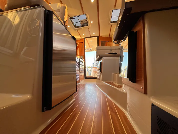 Together Again II Yacht Photos Pics Interior of 2022 Ranger Tugs R-31 CB with wood flooring and modern appliances.