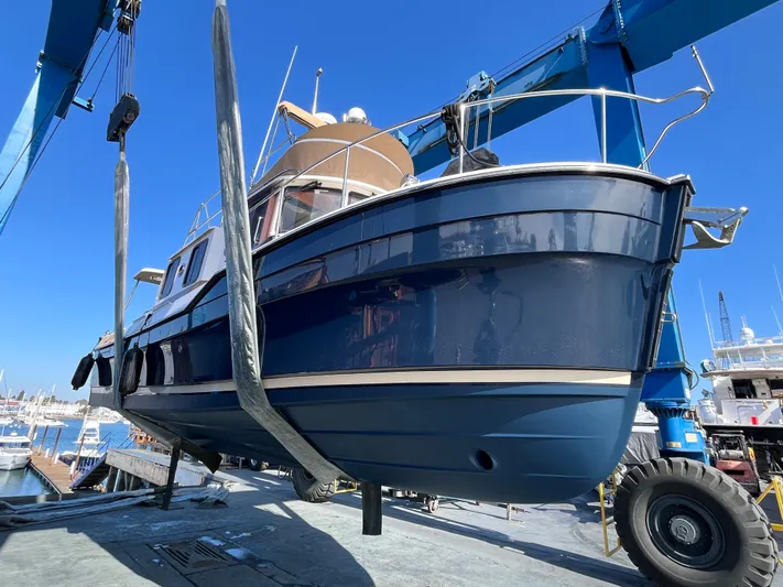 Together Again II Yacht Photos Pics 2022 Ranger Tugs R-31 CB boat being lifted at a marina under clear blue sky.