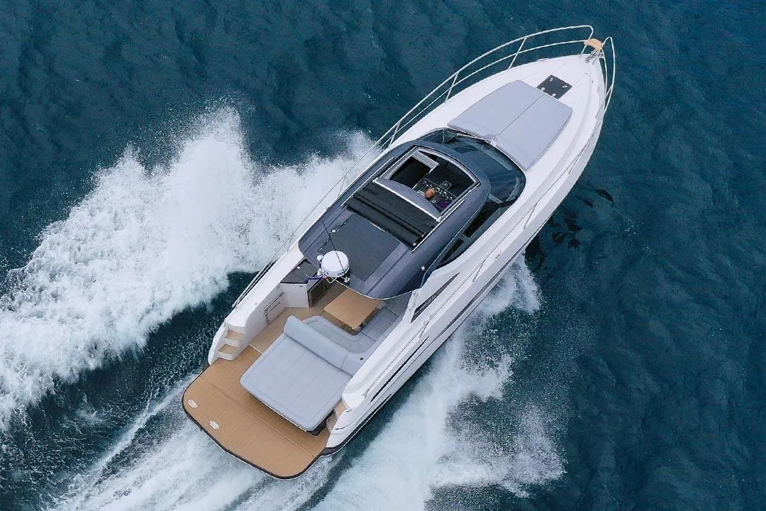2025 Focus Power 36 yacht cruising on open water, aerial view.