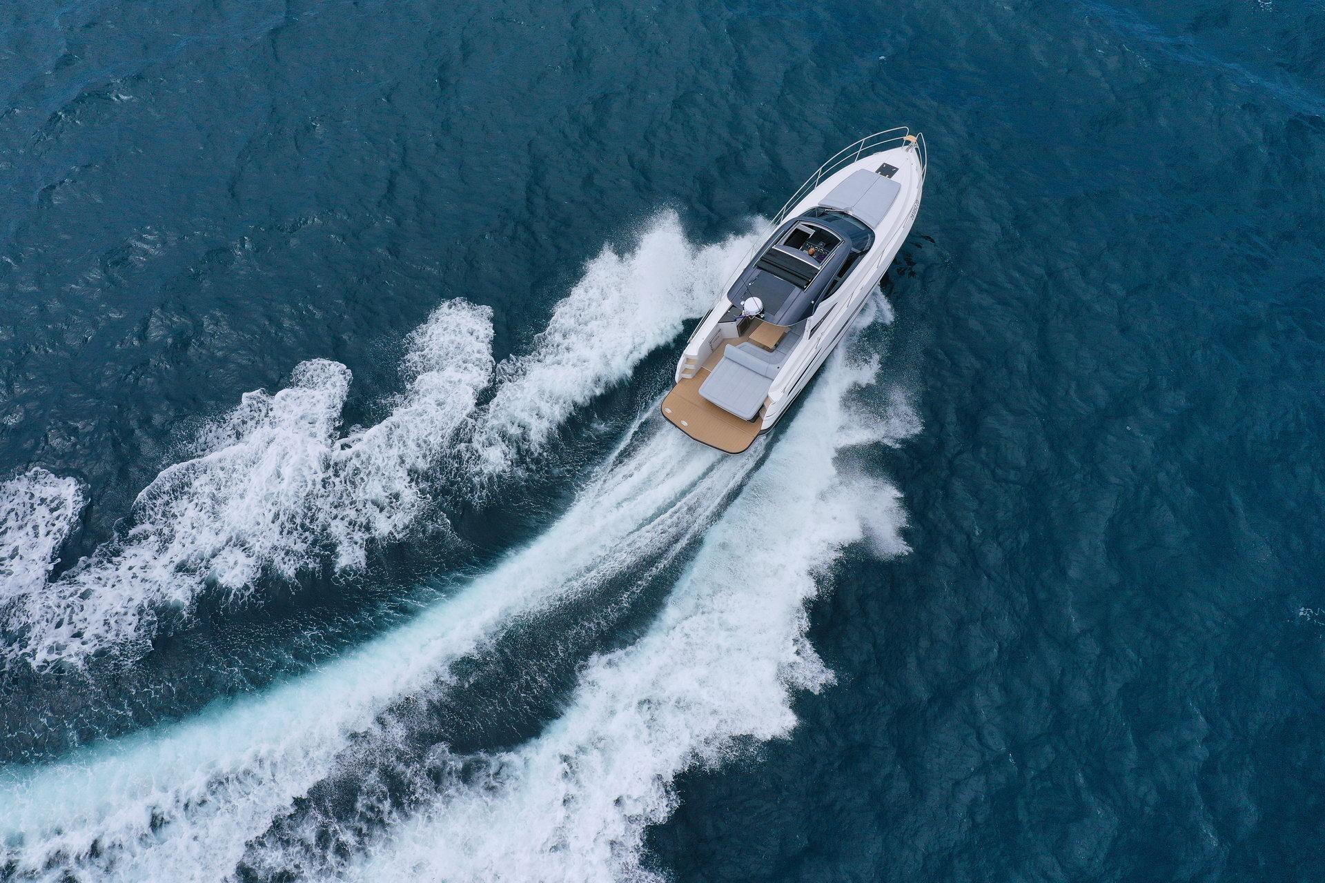 Aerial view of 2025 Focus Power 36 yacht cruising on blue ocean waters.