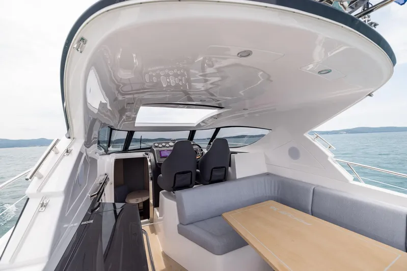  Yacht Photos Pics Modern 2025 Focus Power 36 yacht interior with seating and ocean view.