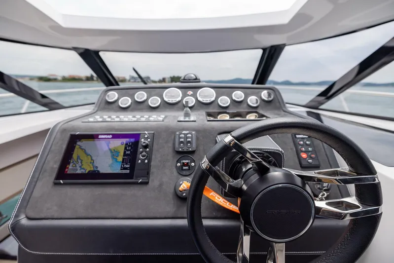  Yacht Photos Pics 2025 Focus Power 36 boat dashboard with navigation system and steering wheel.