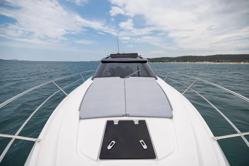  Yacht Photos Pics 2025 Focus Power 36 yacht cruising on open sea under a partly cloudy sky.