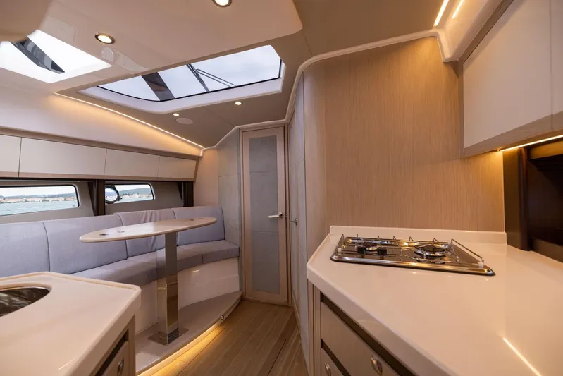  Yacht Photos Pics Luxurious interior of 2025 Focus Power 36 yacht with modern kitchen and seating area.
