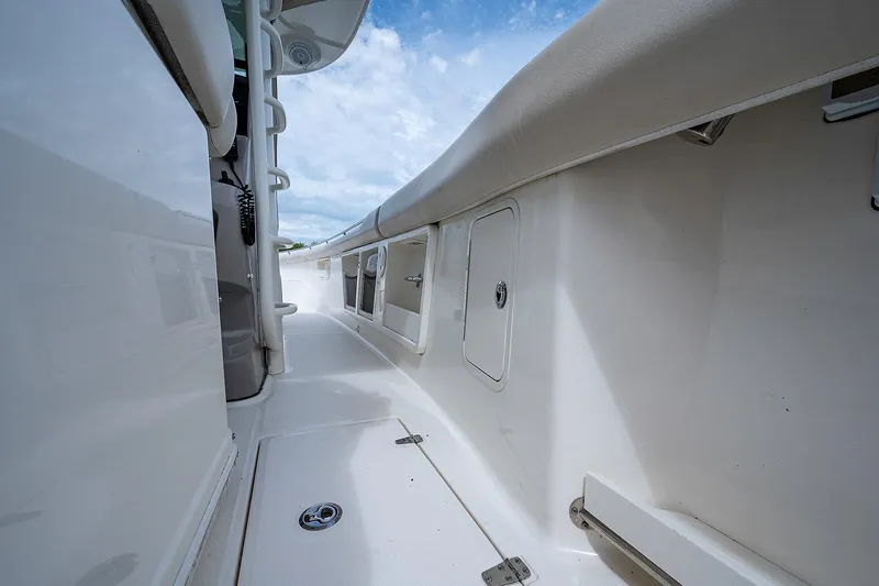 No Surrender Yacht Photos Pics 2017 Boston Whaler 370 Outrage boat deck, featuring sleek white design and storage compartments.