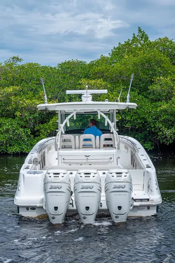 No Surrender Yacht Photos Pics 2017 Boston Whaler 370 Outrage boat with triple engines on a calm waterway.