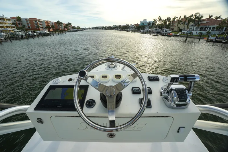  Yacht Photos Pics Steering console of 2013 SeaVee 390B boat overlooking a scenic waterway.