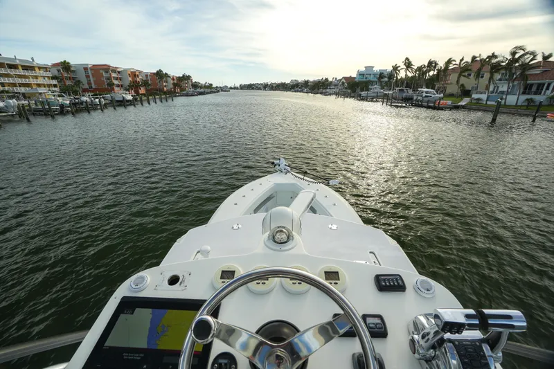  Yacht Photos Pics 2013 SeaVee 390B boat navigating a scenic waterway at sunset.