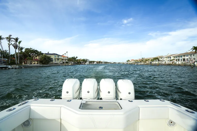  Yacht Photos Pics 2013 SeaVee 390B boat with four engines cruising on a scenic waterway.